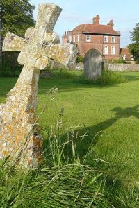  An interesting headstone is caught by the evening sun. Beedon Manor behind. © Copyright Graham Horn and licensed for reuse under this Creative Commons Licence 