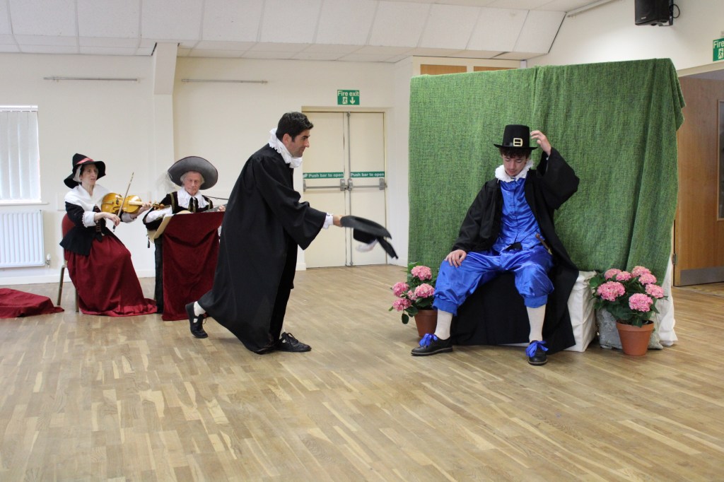 Two men raising their hats to each other