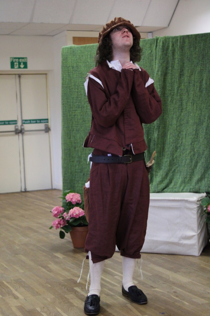 A man looking to the sky and clasping his hands