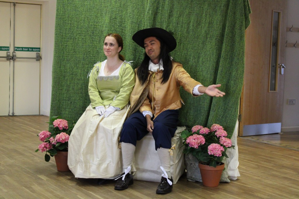 A woman and a man sitting together on a seat