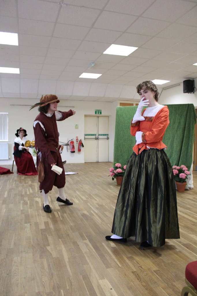 A man and a woman in Tudor costume