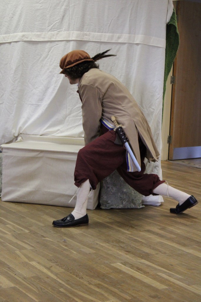 A man pulling on a seat to move it