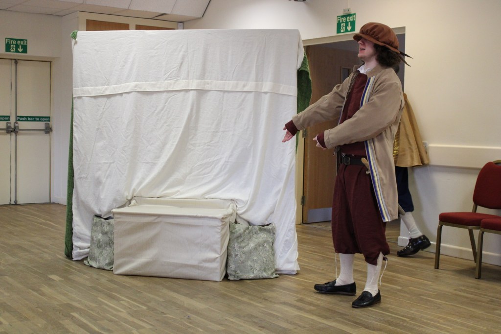 A man gesturing to a seat