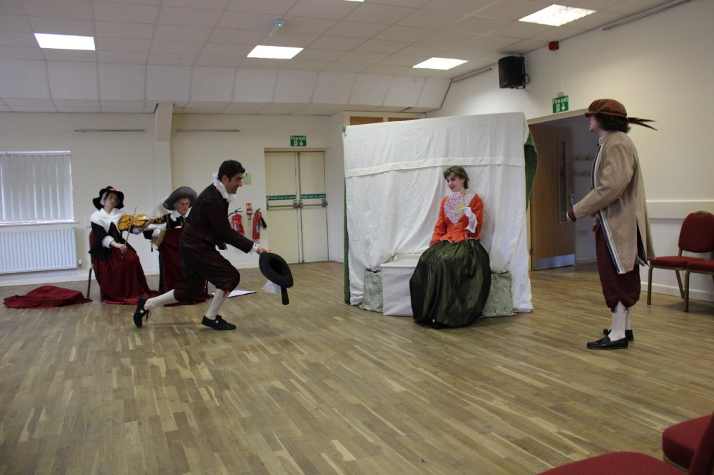 A man bowing to a woman