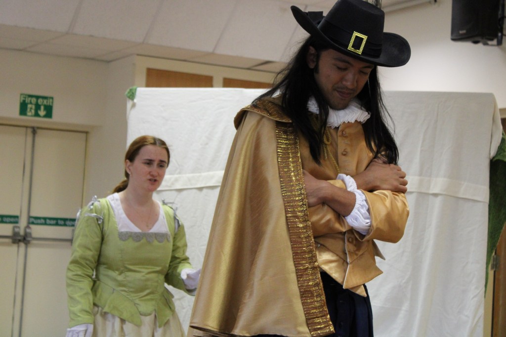 a woman standing behind a man