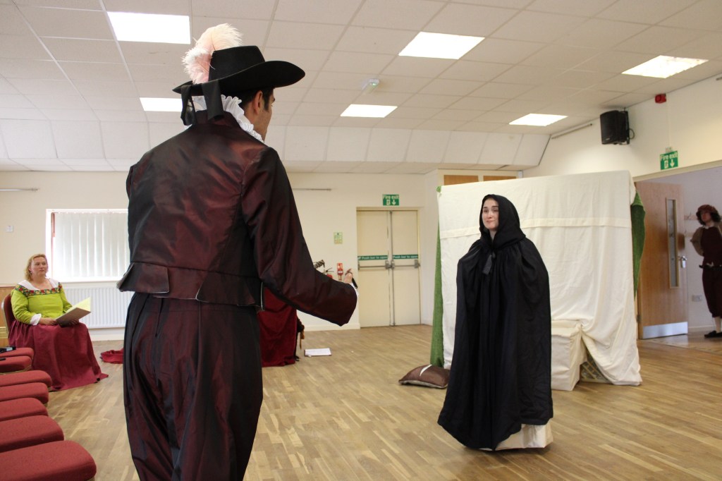 A man talking excitedly to a woman